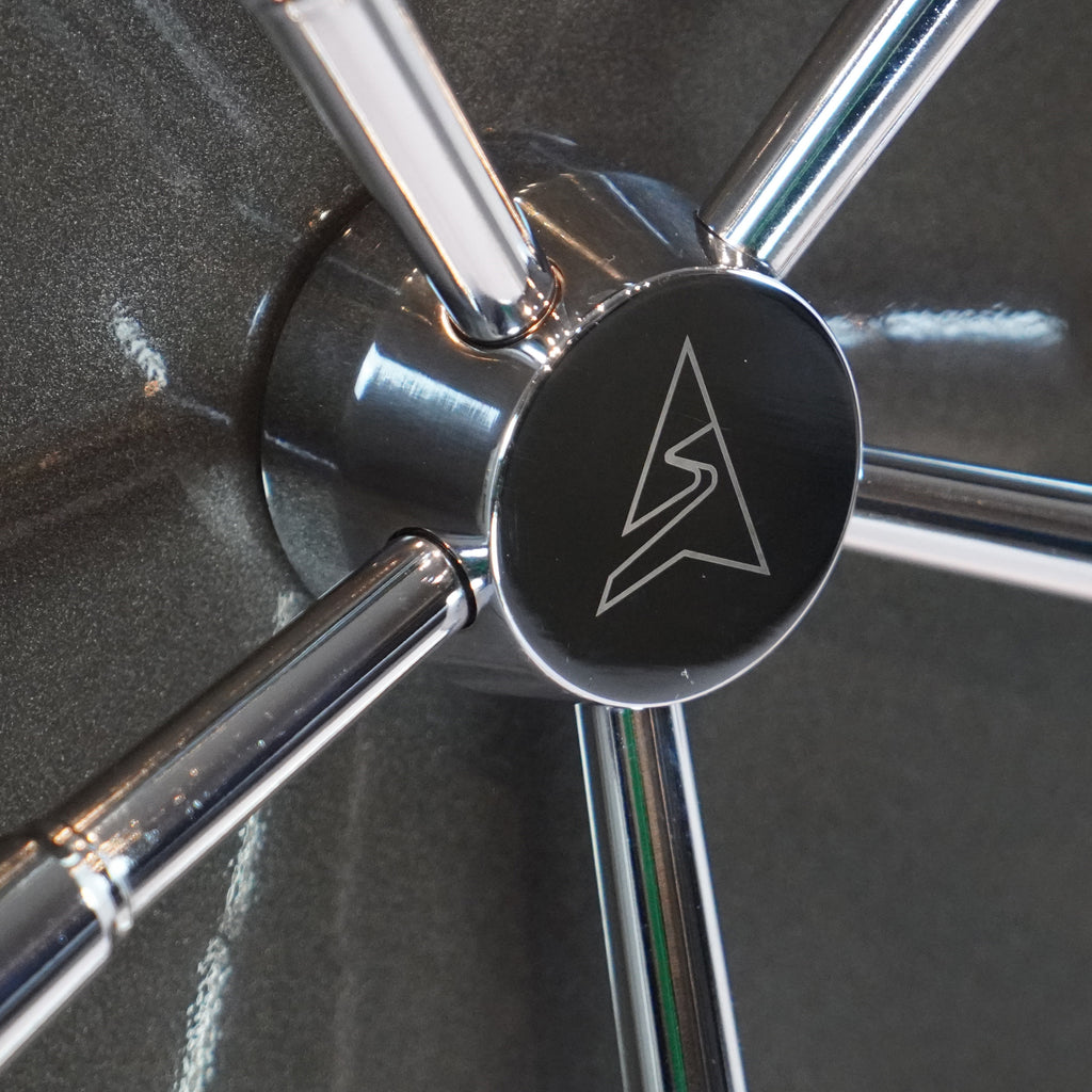Close-up of Sports Afield gun safe handle showcasing chrome locking mechanism and logo detail.