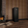 Image of 12-gun fireproof gun safe, Sports Afield Domain Series with Electronic Lock in a rustic interior setting.