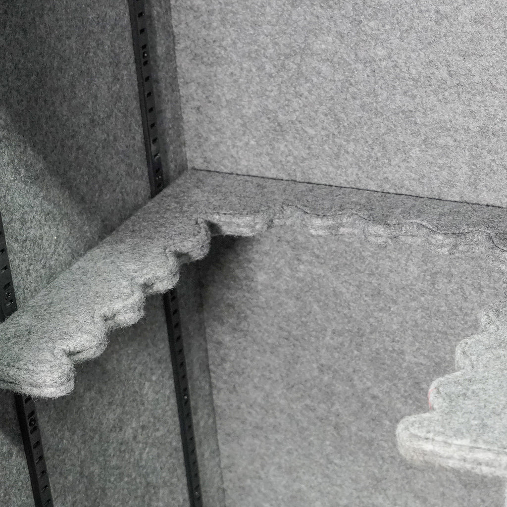 Interior view of a sports gun safe showing felt-lined shelves for firearm protection and organization.