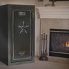 Image of Sports Afield Haven Series fireproof biometric gun safe beside a fireplace, showcasing security and design.