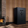 Image of Remington Gun Club fireproof waterproof gun safe displayed in a cozy room next to a fireplace.