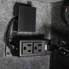 Image of Dual electric outlet with USB port installed in a gray felt interior, ideal for powering devices.