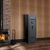 Image of Remington Gun Club fireproof and waterproof gun safe with electronic lock, positioned beside a fireplace in a cozy setting.
